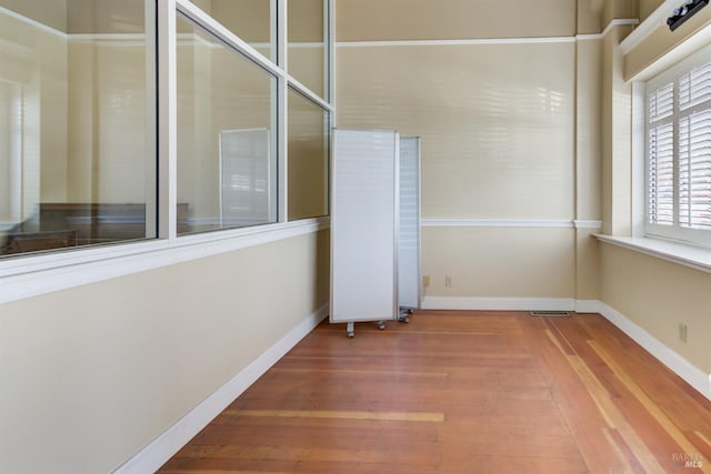 interior space with wood finished floors and baseboards