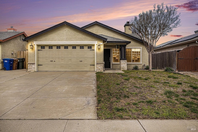 single story home with a garage, fence, stone siding, concrete driveway, and stucco siding