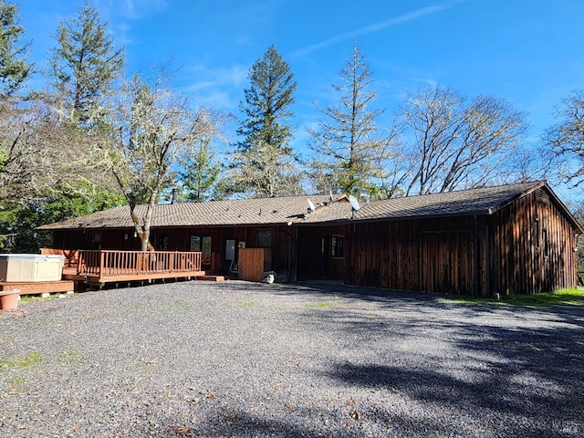 view of front facade with driveway and a wooden deck