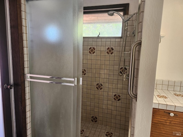 full bathroom featuring a stall shower and a textured wall