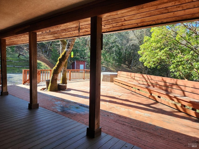 wooden terrace featuring a wooded view