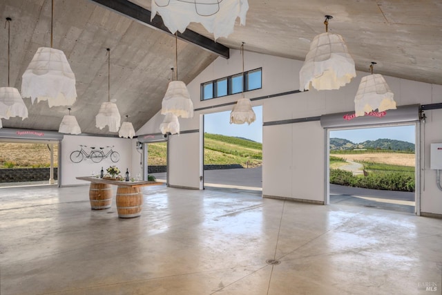 interior space featuring finished concrete floors and high vaulted ceiling