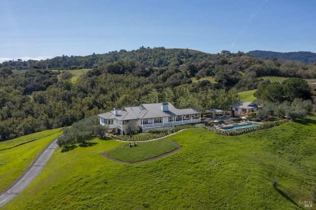 drone / aerial view with a wooded view