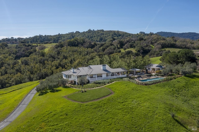 birds eye view of property with a view of trees