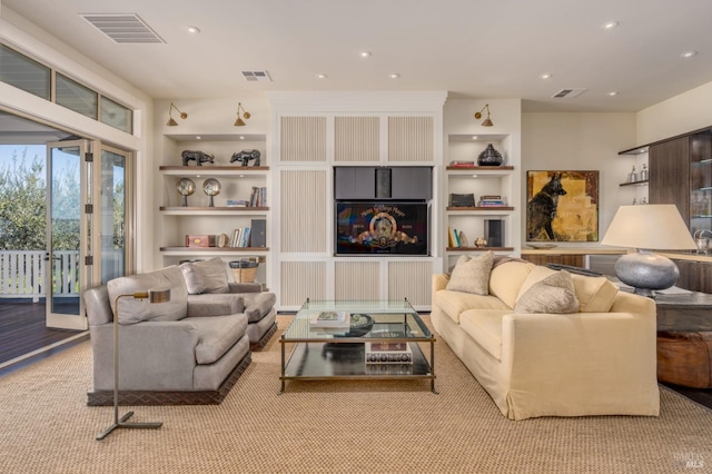 living room with built in features, recessed lighting, and visible vents