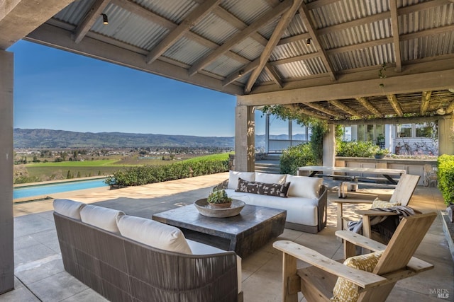 view of patio / terrace featuring an outdoor living space, a mountain view, a gazebo, and a pool