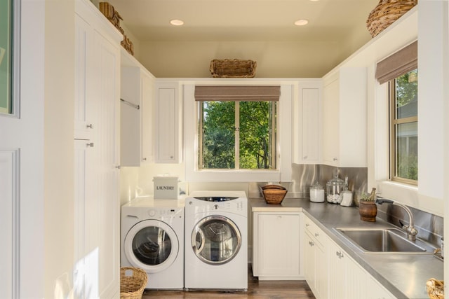laundry area with separate washer and dryer, cabinet space, and a sink