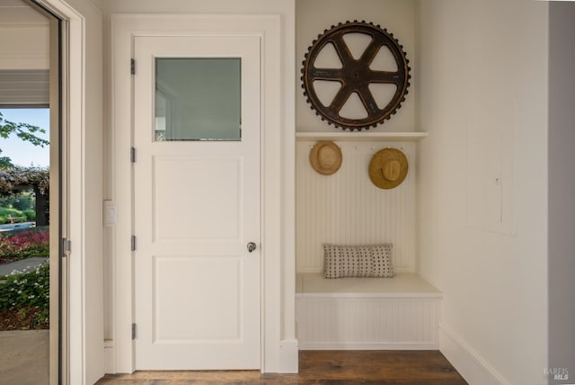 mudroom featuring dark wood finished floors and baseboards