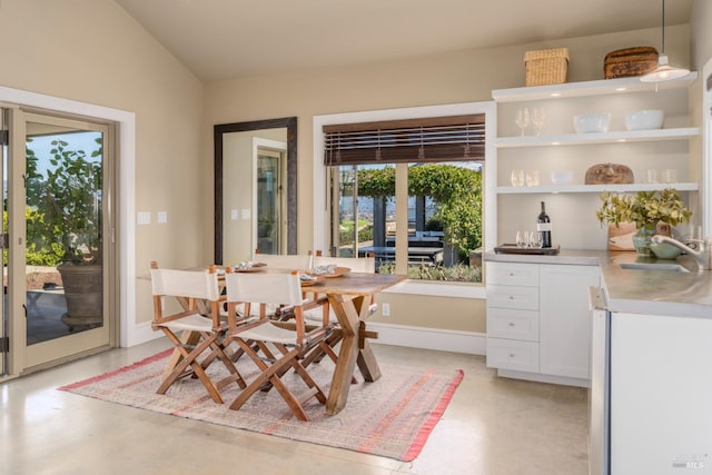 dining room featuring vaulted ceiling and baseboards