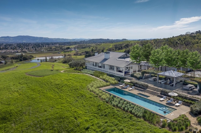 drone / aerial view featuring a water and mountain view