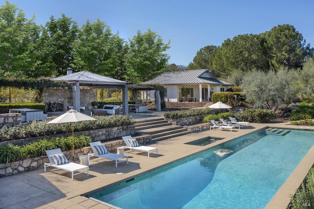 outdoor pool with a jacuzzi, a gazebo, a patio, and outdoor lounge area