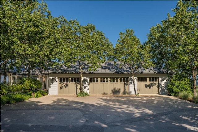 single story home featuring a garage and driveway