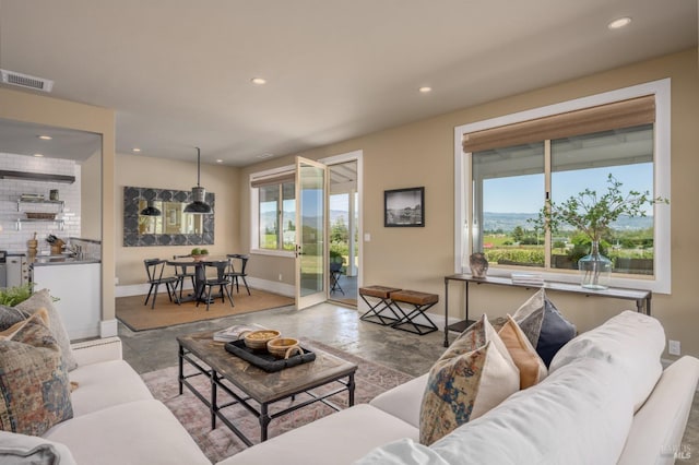living room featuring recessed lighting, visible vents, and baseboards
