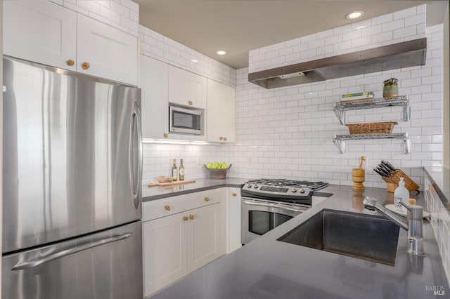 kitchen featuring stainless steel appliances, open shelves, a sink, tasteful backsplash, and white cabinetry