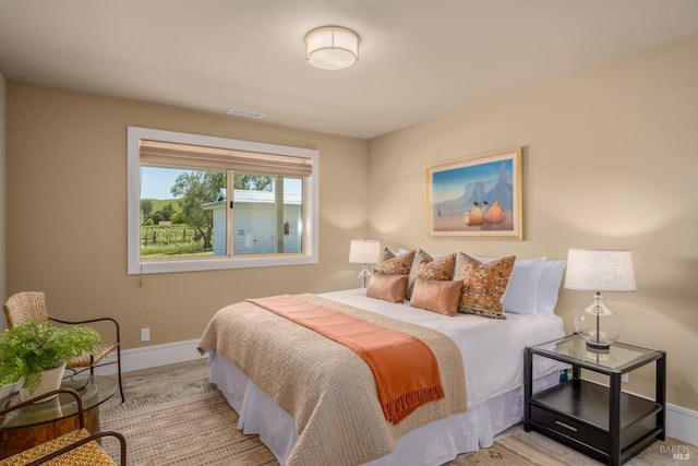 bedroom featuring baseboards and wood finished floors