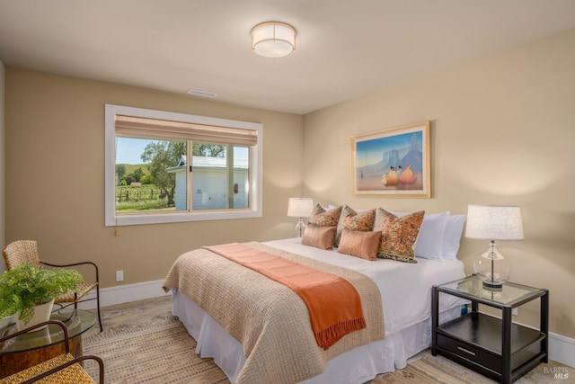 bedroom featuring visible vents and baseboards