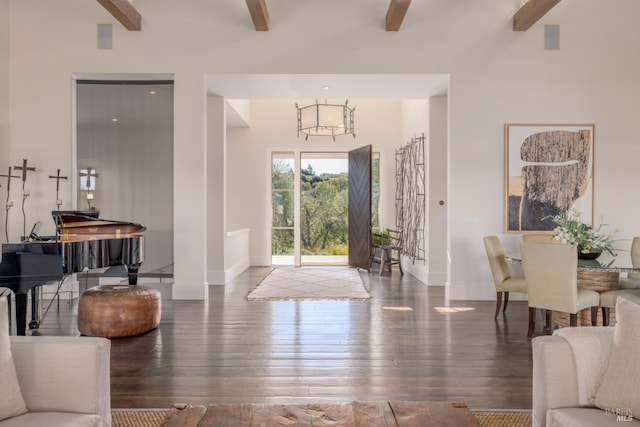 entrance foyer featuring baseboards, a chandelier, beamed ceiling, hardwood / wood-style floors, and high vaulted ceiling