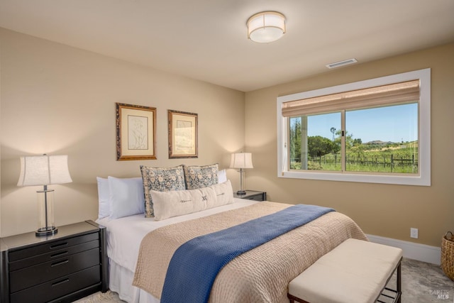 bedroom featuring baseboards and visible vents