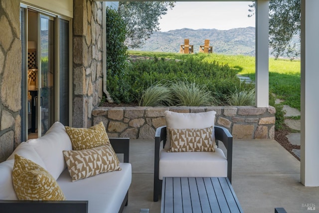 view of patio / terrace featuring an outdoor hangout area and a mountain view