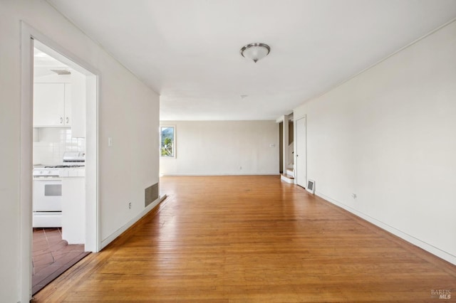 interior space with light wood-style flooring, baseboards, and visible vents