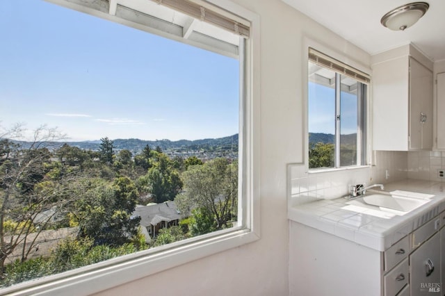 bathroom featuring vanity, a mountain view, and backsplash