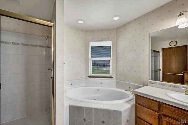 full bathroom with a garden tub, a shower stall, vanity, and wallpapered walls