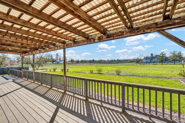 wooden terrace featuring a rural view and a lawn