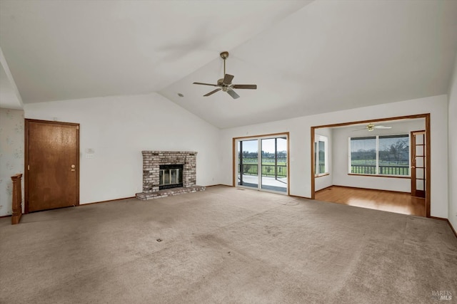 unfurnished living room with high vaulted ceiling, a fireplace, a ceiling fan, and carpet flooring