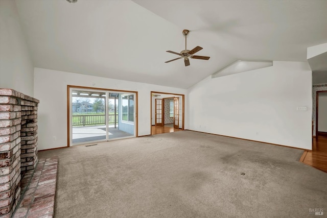 unfurnished living room with high vaulted ceiling, carpet floors, visible vents, baseboards, and a ceiling fan