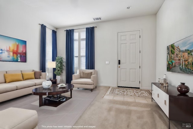 tiled living area with baseboards and visible vents