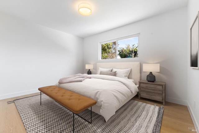 bedroom featuring light wood-style flooring and baseboards