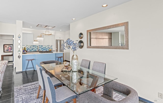 dining space with baseboards and recessed lighting