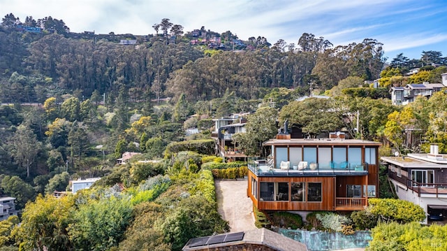 birds eye view of property featuring a wooded view