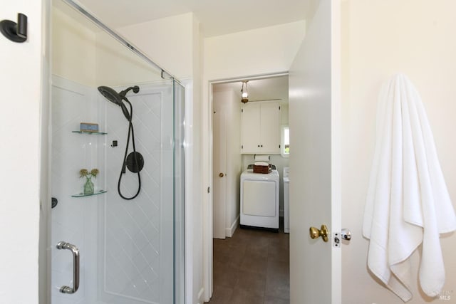 full bathroom featuring walk in shower and washing machine and dryer