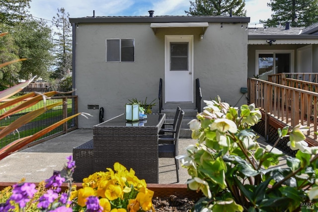 back of property with a patio area, fence, and stucco siding