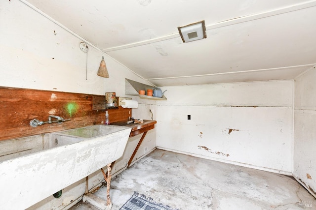 kitchen featuring concrete flooring and a sink