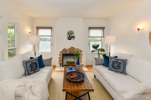 living room with a fireplace and light wood-style floors