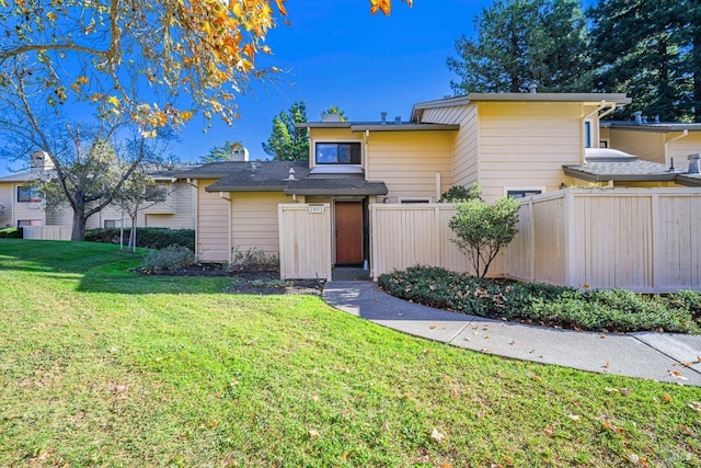 view of front facade with a front yard and fence