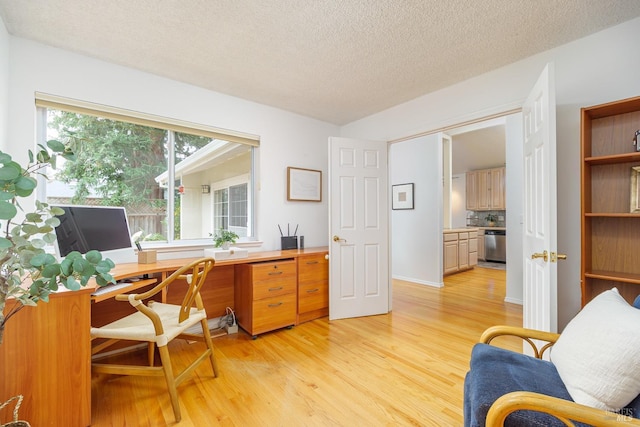 office space with a textured ceiling and light wood-style flooring