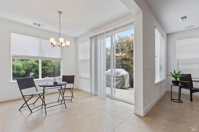 dining space featuring a wealth of natural light, visible vents, and an inviting chandelier