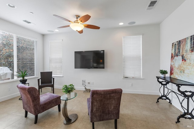 tiled living room featuring baseboards, visible vents, and recessed lighting