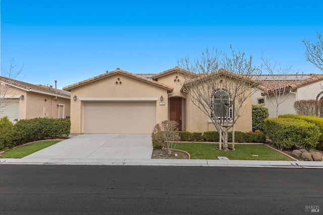 mediterranean / spanish home with a tile roof, stucco siding, an attached garage, driveway, and a front lawn