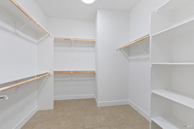 spacious closet featuring tile patterned flooring