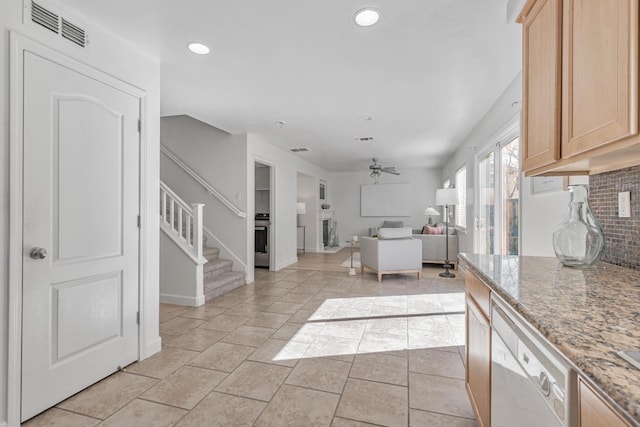 kitchen featuring visible vents, backsplash, light brown cabinets, ceiling fan, and open floor plan