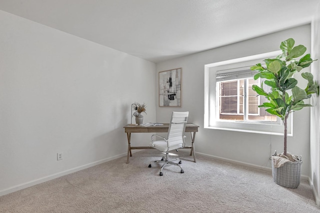 carpeted office space with baseboards