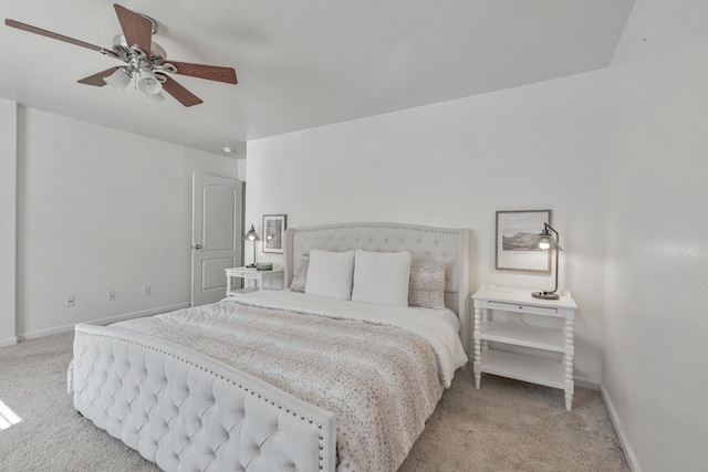 carpeted bedroom featuring baseboards and ceiling fan