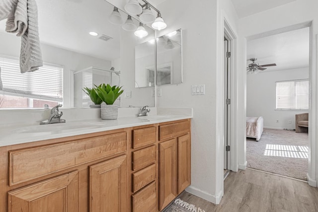 full bathroom with visible vents, a shower stall, ensuite bathroom, and a sink