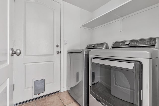 washroom with separate washer and dryer and laundry area