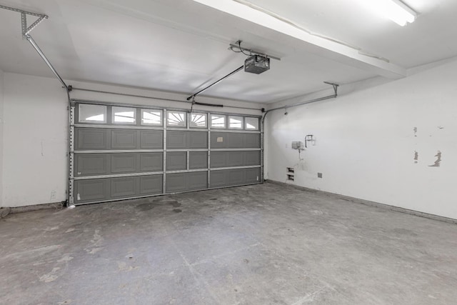 garage featuring baseboards and a garage door opener