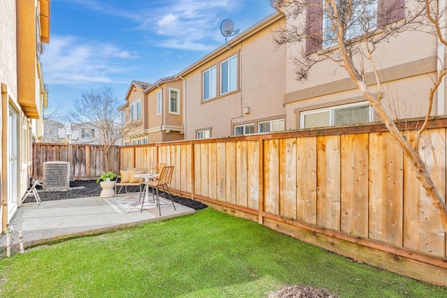 view of yard featuring a patio area, a residential view, central AC, and a fenced backyard